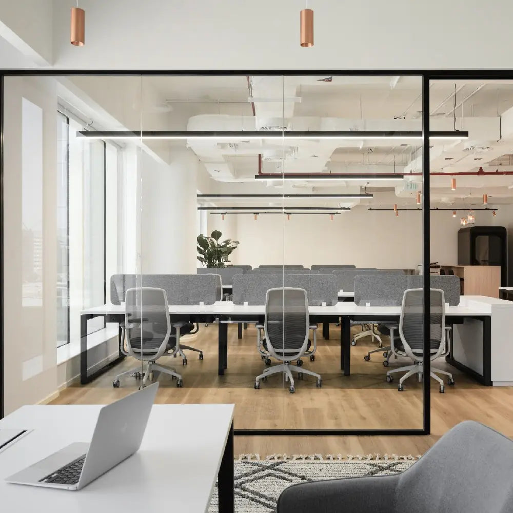 Prestigious office with natural light and scenic views, large open plan with view of workstations, phone booth and managers office