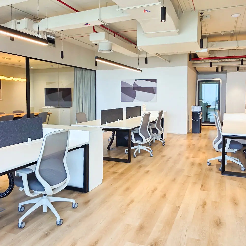 Workstation cluster with 4 desks near phone booth