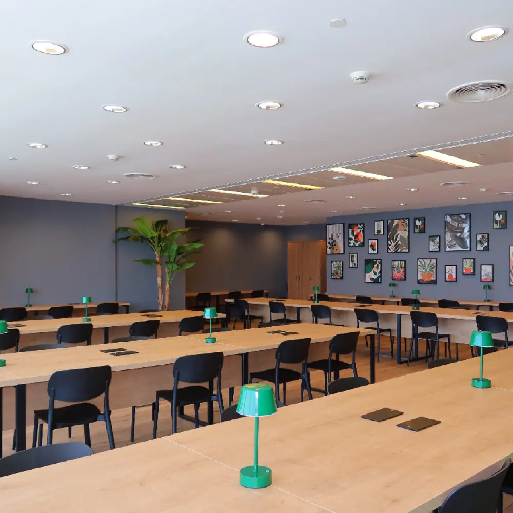Modern coworking area with shared desks and green desk lamps at The Work Oasis, Sky Tower, Abu Dhabi