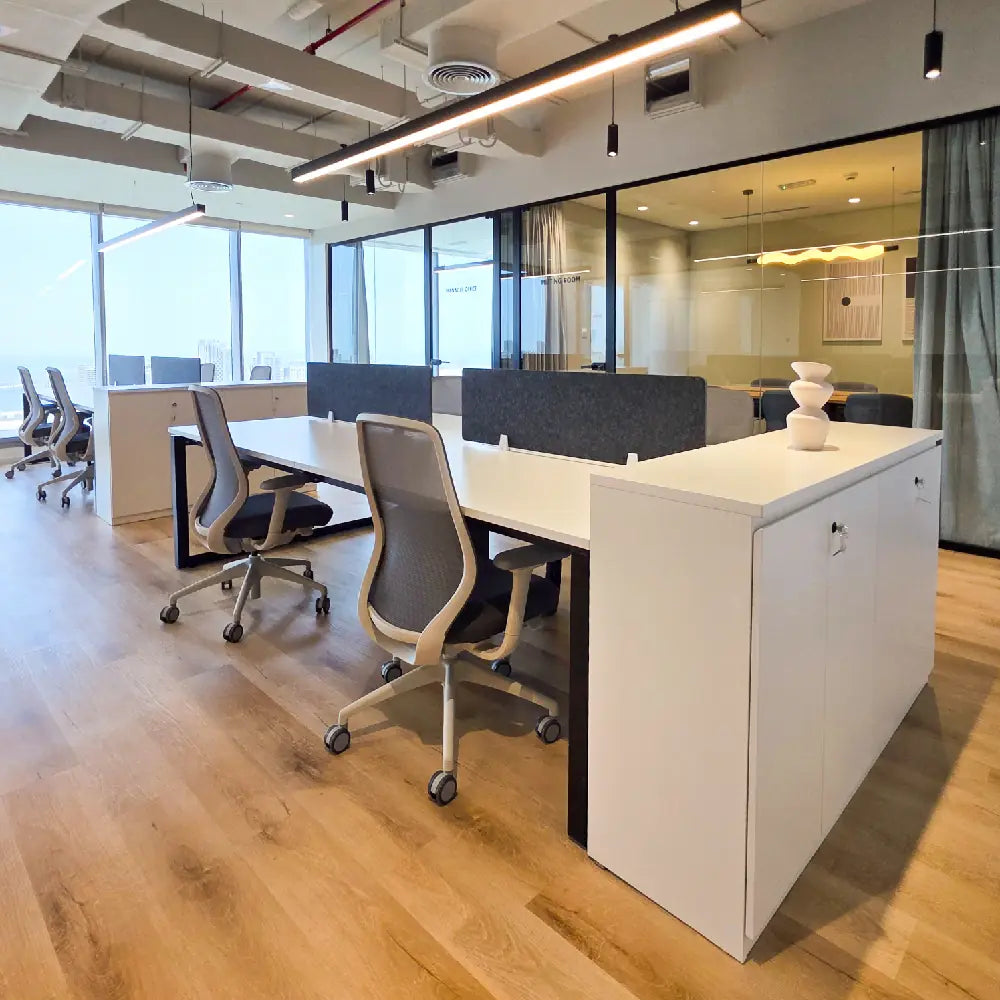 Open-plan desk area with natural light and city views