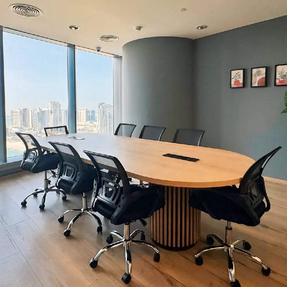 Professional meeting room for eight with city views at The Work Oasis, Abu Dhabi.