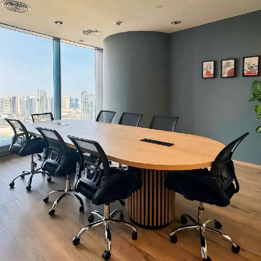 Professional meeting room for 8 with city views at The Work Oasis, Abu Dhabi.