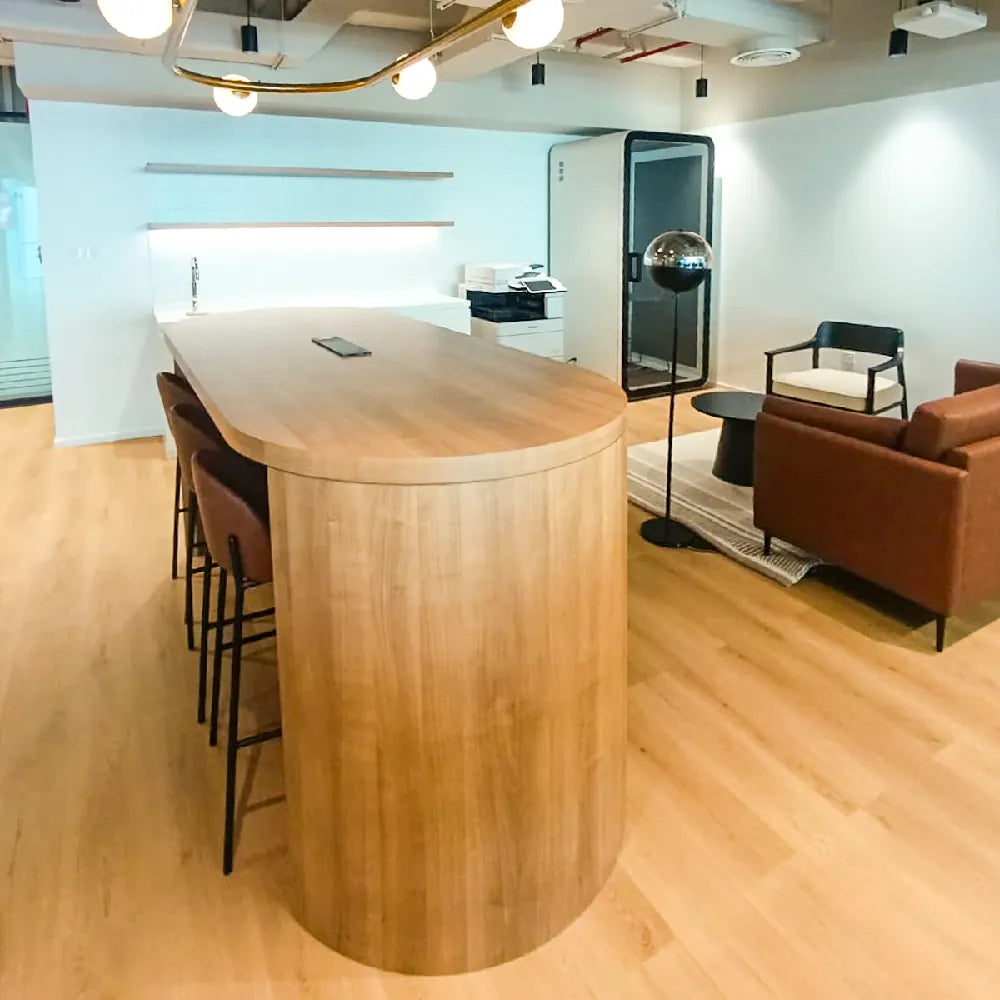 Built-in hot desk bar with stools and kitchenette, ideal for casual work sessions