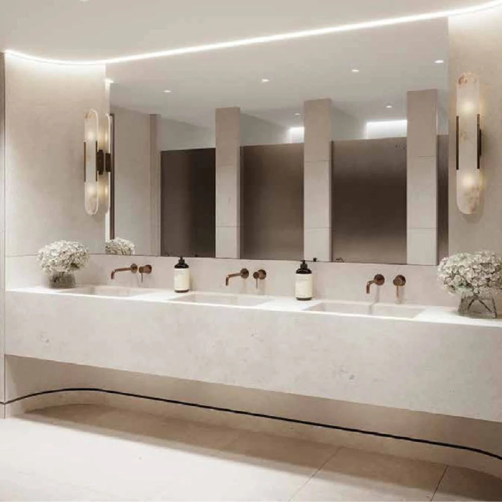 Modern bathroom with a long vanity mirror, lights, and decorative elements.