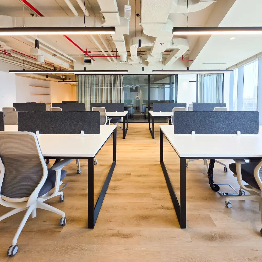 Alternative angle showing spacious workstation layout and natural light