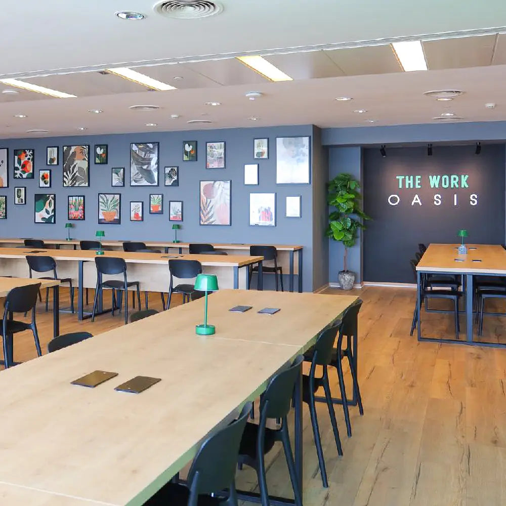 Spacious coworking space with decorative wall art at The Work Oasis, Abu Dhabi.