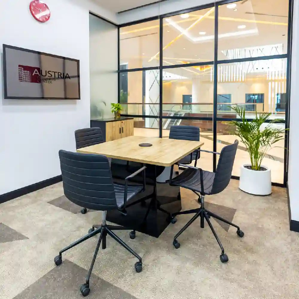 Small meeting room seating 4 people at Austria Business Center, Al Hudaiba Mall