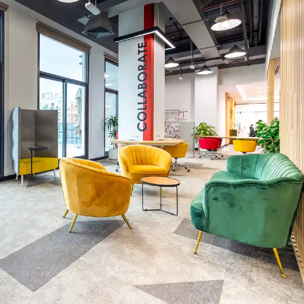 Bright coworking lounge with colourful seating and collaboration areas at Austria Business Center, Al Hudaiba Mall.