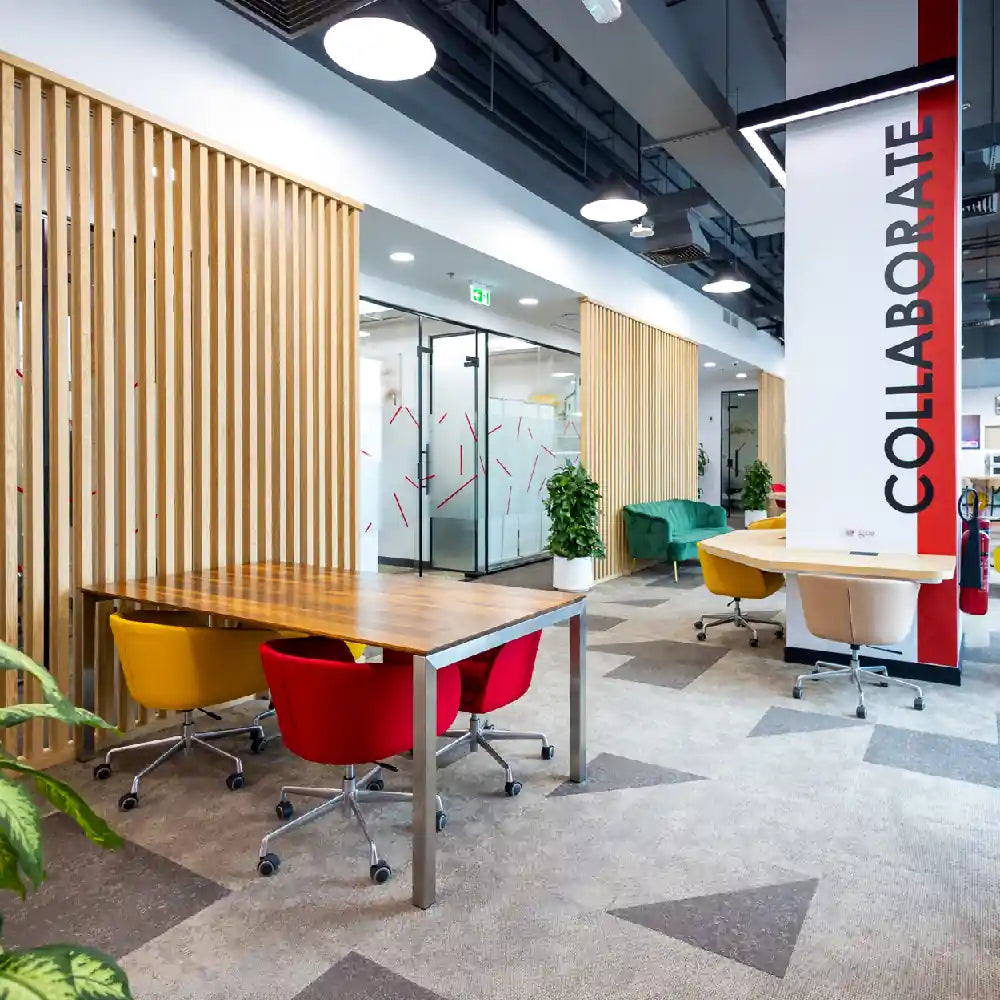 Shared coworking space with natural light and modern design at Austria Business Center, Al Hudaiba Mall.