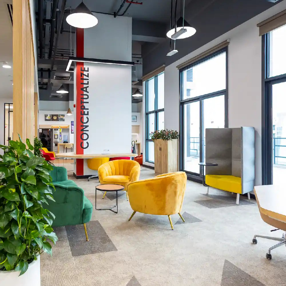Colourful coworking lounge with seating and collaboration areas at Austria Business Center, Al Hudaiba Mall