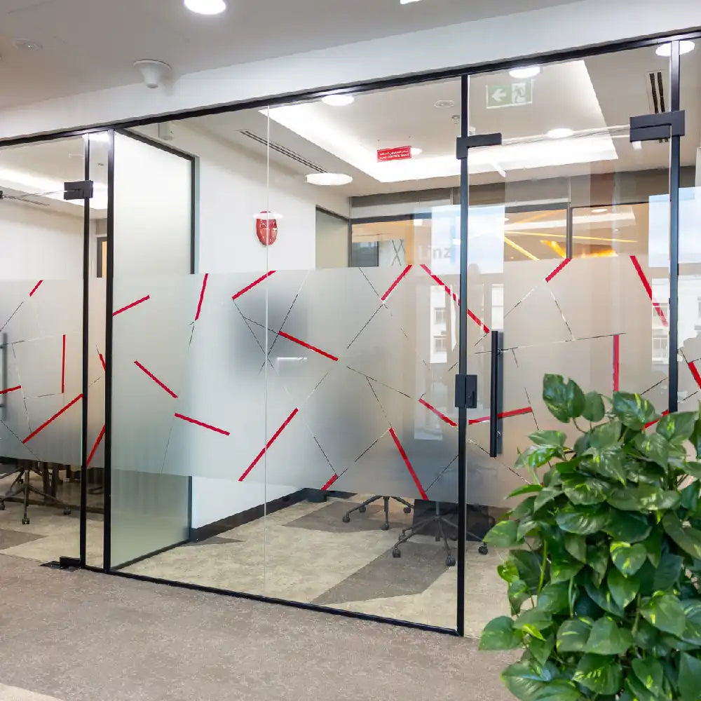 Modern glass-partitioned office hallway at Austria Business Center, Al Hudaiba Mall.