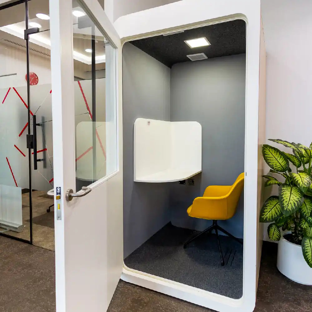Soundproof phone booth with chair for private calls at Austria Business Center, Al Hudaiba Mall