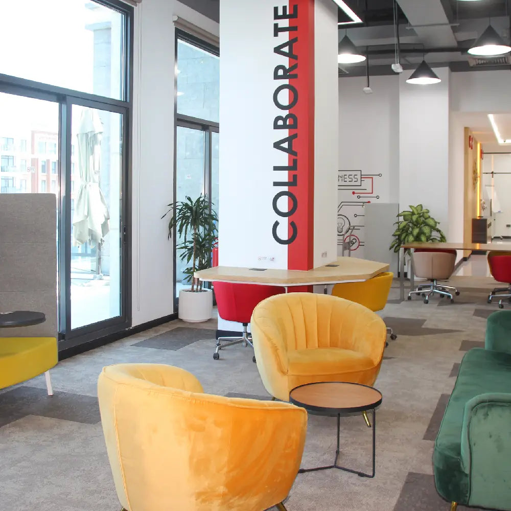 Vibrant coworking lounge with colourful seating and collaboration spaces at Austria Business Center, Al Hudaiba Mall