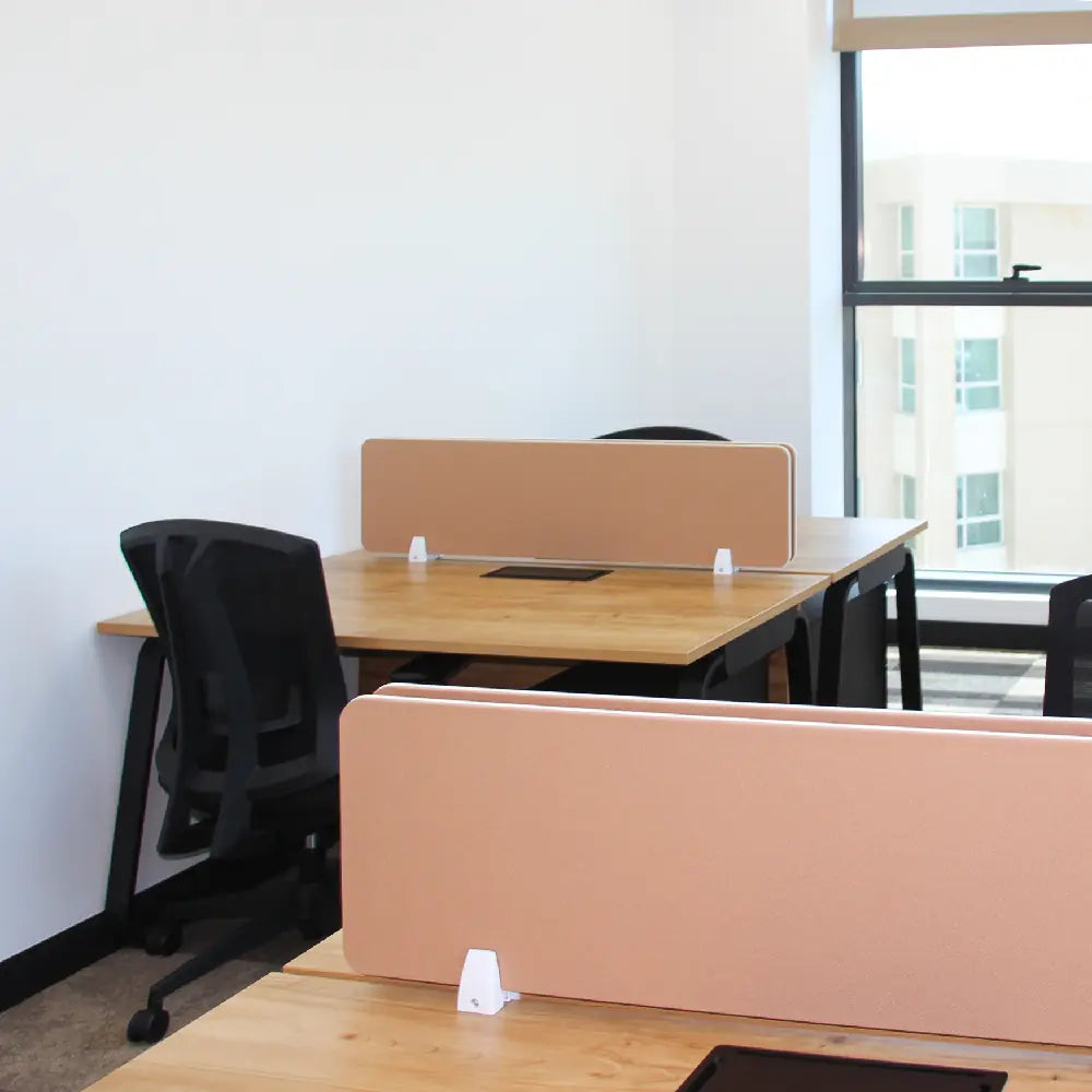 Spacious 6-desk private office with ergonomic chairs and windows at Austria Business Center, Al Hudaiba Mall.