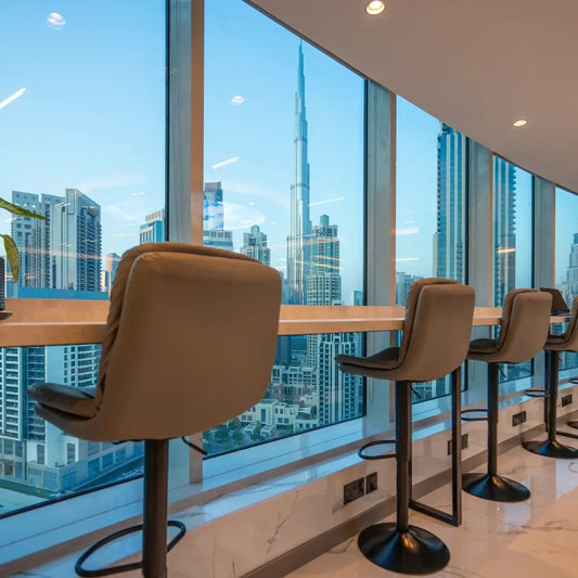 Jetset Serviced Offices in Business Bay. Modern interior with bar stools with stunning views of the Dubai Burj Khalifa