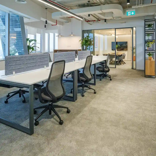 Glass-partitioned meeting room viewed from shared workstations at Rice – Al Salam Tower