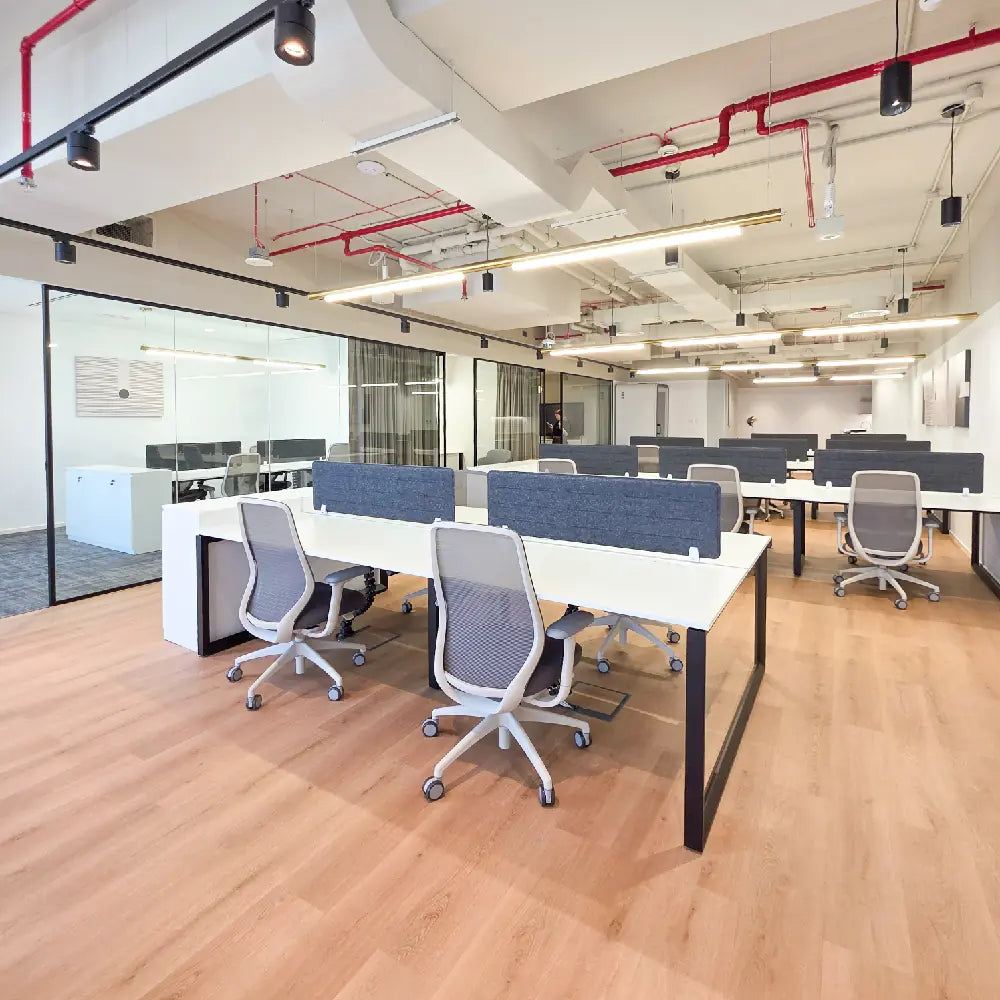Open-plan corporate office with modern workstations and natural light at RICE Burj Al Salam