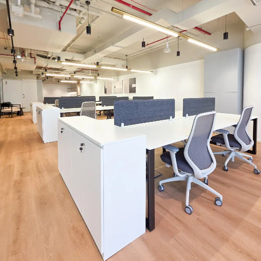Wide-angle view of ergonomic desk setup and open workspace design