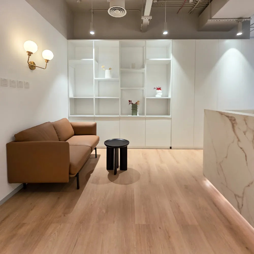 Soft seating lounge near wall-mounted cabinetry and ambient lighting