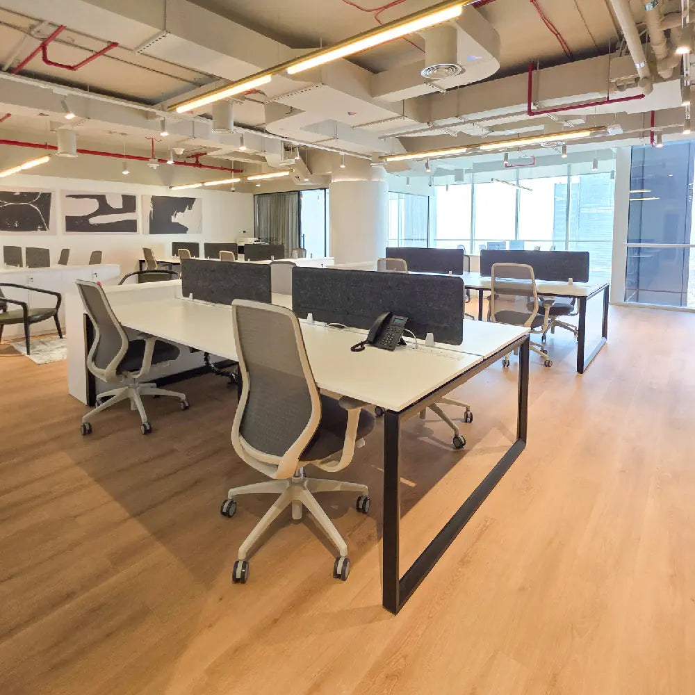 Spacious open-plan workspace with ergonomic desks and skyline light