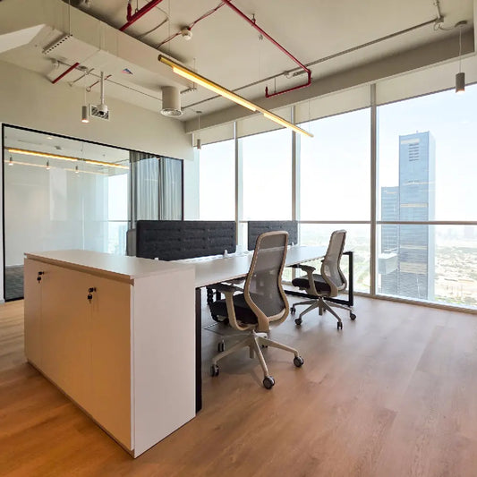 Natural light streaming over modern workstation layout in Burj Al Salam