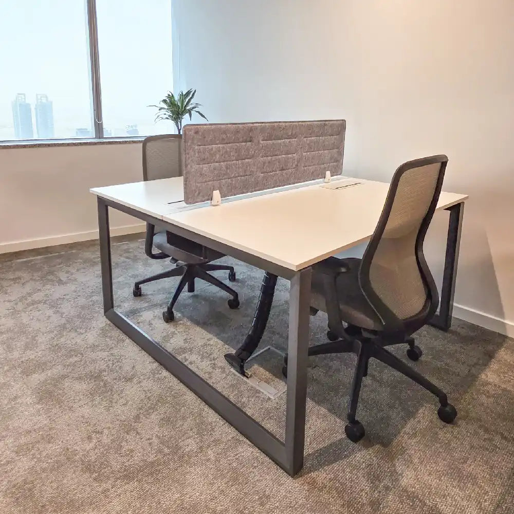 Close-up of secondary desk layout beside window with privacy dividers
