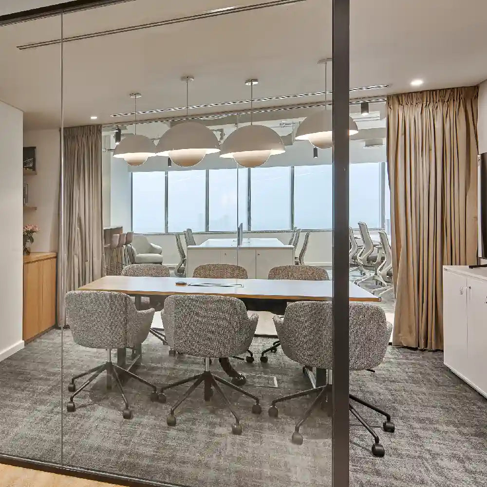 Alternate view of meeting room and breakout seating beyond glass wall