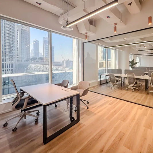 Modern managers office with large windows, desks, and chairs.