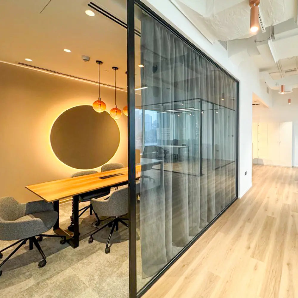 Modern office space with glass walls and wooden flooring