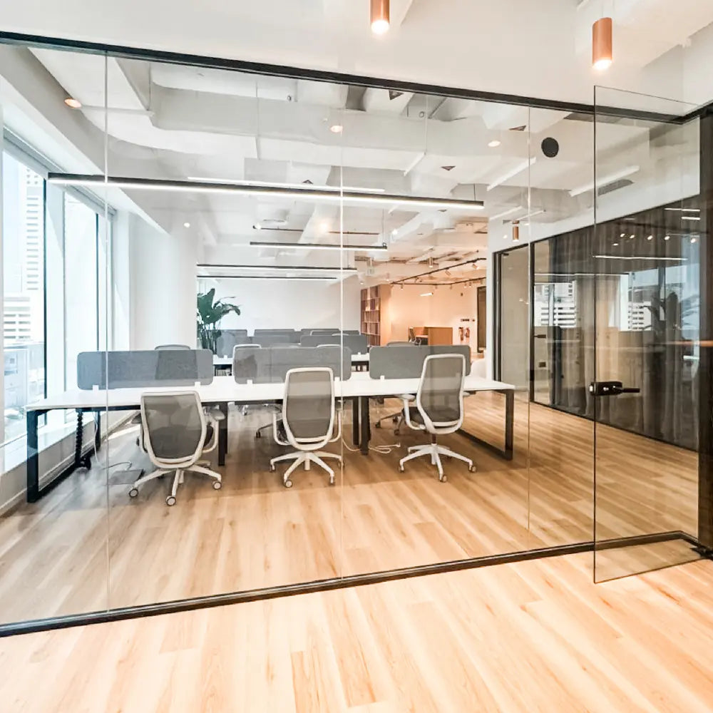 Modern office space with glass walls and furniture