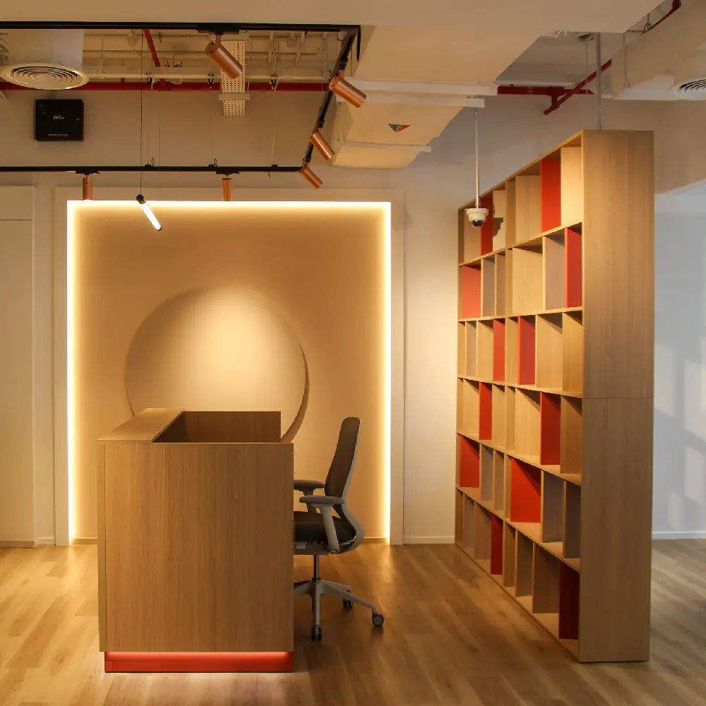 Reception desk with signature lighting feature and shelving at Space1 Office 6