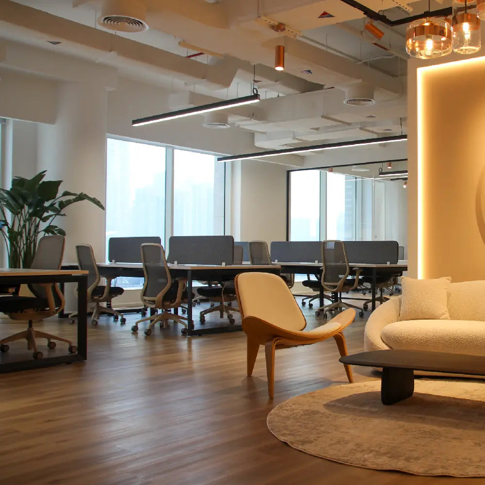 Reception seating area with open-plan workstations and soft lighting at Space1 Office 6