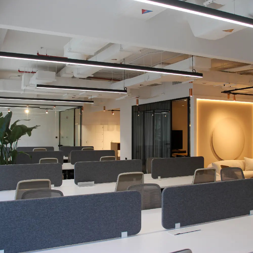 Spacious open-plan office with workstations and glass meeting room