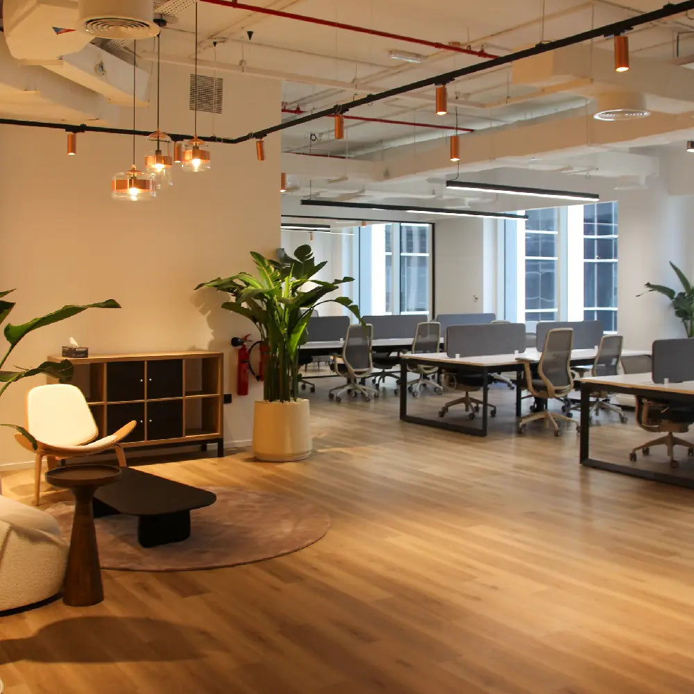 Open-plan office lobby with greenery and seating at Space1